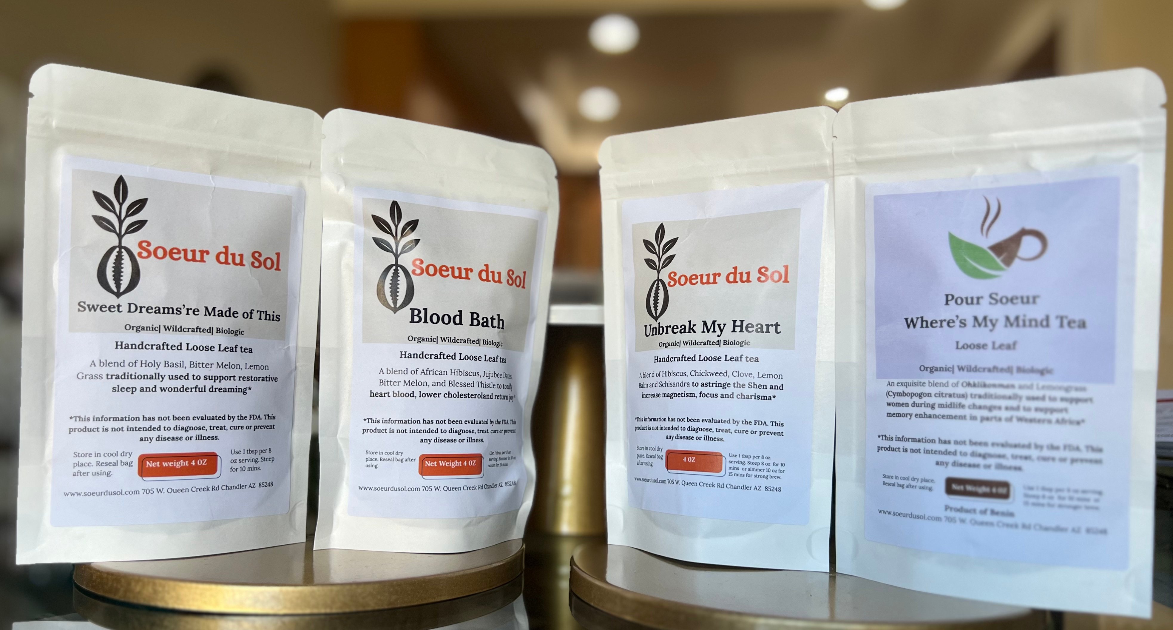 4bags of tea with colorful labels all in white paper bags
